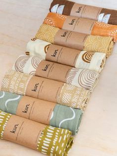 the rolled up papers are lined up on the counter top with different colors and patterns