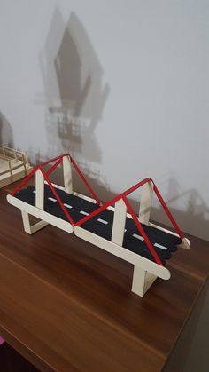 a wooden table topped with a toy car and ramp