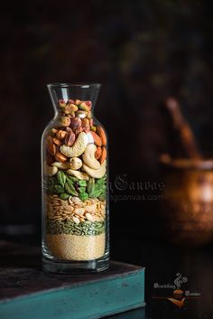 a glass jar filled with lots of different types of nuts