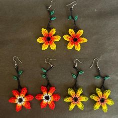 Traditional Mexican Handmade Huichol chaquira (beaded) earrings made by Mexican artisans in the Mexican state of Chipas. The earrings are lightweight, colorful and sure to bring you lots of compliments.  The length is approximately 3 inches and 1.5 inches wide. Multicolor Handmade Flower Earrings, Bohemian Multicolor Handmade Flower Earrings, Handmade Multicolor Flower Earrings, Multicolor Handmade Flowers Bohemian Earrings, Traditional Flower Shaped Beaded Earrings, Traditional Flower Shaped Beaded Earrings For Festivals, Traditional Handmade Flower Beaded Earrings, Multicolor Flower-shaped Festival Earrings, Traditional Flower Earrings For Festival