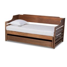 a wooden bed with white sheets and pillows