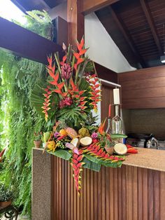 an arrangement of tropical flowers on the counter