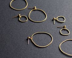 These dainty gold hoop earrings are no-brainers each lovely morning! Keep it classic with a small or large pair. Or make it cool and funky with an asymmetric mismatched pair! * Brass freeform rings * Gold plated ball ear studs * Plastic stoppers included SMALL: Total length around 22mm (0.875in). LARGE: Total length around 42mm (1.675in). ASYMMETRIC PAIR: one small earring + one large earring! :) Each pair is truly unique, because hammered by hand! Ring's shape can vary from picture, but will be Small Diamond Stud Earrings, Plain Silver Rings, Brass Hoop Earrings, Geode Earrings, Abstract Earrings, Asymmetrical Earrings, Dainty Gold Necklace, Mismatched Earrings, Large Earrings