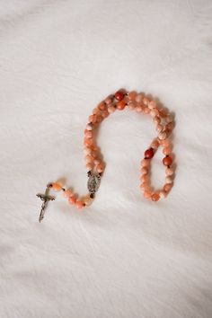 “It is love alone that gives worth to all things.” // Saint Teresa of Avila Introducing handcrafted Rosaries, prayerfully created by Blessed is She and inspired by great Saints. Carefully designed to be durable and beautiful, we’re honored to bring this prayer tool into your hands. This Rosary, inspired by Saint Teresa of Avila, features fiery, multicolored oranges and reds inspired by her passion for Jesus. Each bead of this Rosary is meticulously crafted from high-quality matte stones, creatin