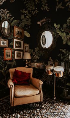 a living room with a chair, table and pictures on the wall