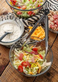 three bowls filled with different types of food on top of a wooden table next to other dishes