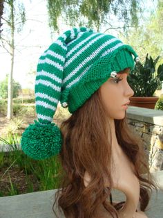 a mannequin head wearing a green and white hat