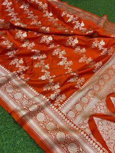 This is a very beautiful high quality mashru silk saree . All over zari motifs design with border . Saree length - 5.5 mtr. Blouse - 1 mtr. Dry clean only . Please note - color may be vary a little due to sunlight and photography . Please message us after purchasing in case you want fall and Pico done it not . No extra charges for fall and Pico but inform us . Blouse stitching is also available . Katan Silk Pre-draped Saree With Motifs For Designer Wear, Designer Dola Silk Saree With Motifs, Orange Anarkali Katan Silk Dupatta, Anarkali Style Orange Katan Silk Dupatta, Anarkali Orange Saree With Zari Weaving, Designer Jamawar Saree For Navratri, Navratri Jamawar Saree, Elegant Semi-stitched Orange Saree, Elegant Orange Semi-stitched Saree