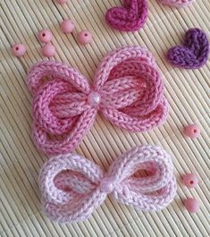 crocheted bows and buttons laid out on a mat