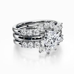 two wedding rings with diamonds on top and bottom, one in white gold the other in silver