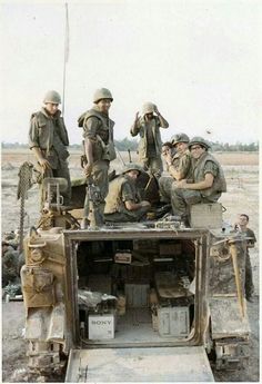 some soldiers are sitting in the back of a truck