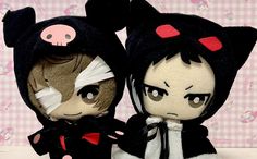 two dolls are dressed in black and white outfits