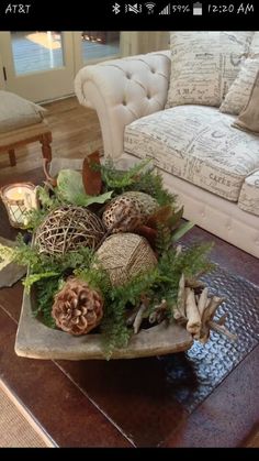 a living room filled with furniture and lots of decorations on top of a table in front of a couch