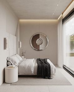 a bedroom with a large bed and a round mirror on the wall next to it