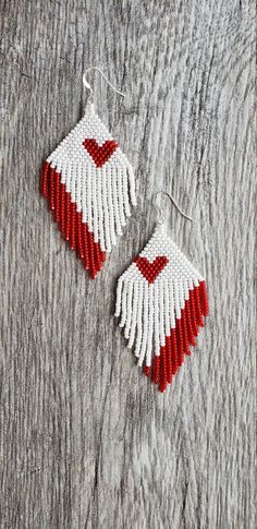 red and white beaded earrings with hearts on them