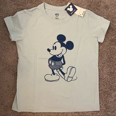 Brand New With Tags. Size M. Casual Blue Shirt With Character Print, Uniqlo Graphic Tee With Crew Neck, Light Blue Cartoon Print Graphic Tee, Light Blue Casual Tops With Cartoon Print, Casual Light Blue Tops With Cartoon Print, Blue Mickey Mouse Short Sleeve Tops, Blue Short Sleeve Tops With Mickey Mouse, Uniqlo Cotton Graphic Tee, Uniqlo Casual Graphic Print T-shirt