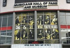 an outside view of a building with many pictures on the front and side windows that read, musicians hall of fame and museum what you've heard?