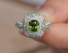 *Condition: Brand new *Center Stone: Natura Tsavorite Green Garnet, Cushion Shape, approx 1.15ct *Side Stone: Natural white diamond, round cut (VS1 clarity and F color) Natural Tsavorite round cut *Ring Weight: 5.62g (depend on the ring size) *Metal Purity: Optional Each piece is made-to-order with care and special attention to detail. all items are made with conflict-free diamonds and gems. Size: made to order The item will be gift wrapped and shipped. ------------------------------------------ Luxury Green Cluster Ring With Round Cut, Luxury Green Sapphire Promise Ring, Luxury Green Halo Ring For Anniversary, Oval Green Sapphire Ring With Halo Setting, Formal Green Cluster Ring With Halo, Luxury Green Oval Cluster Ring, Formal Green Halo Cluster Ring, Luxury Green Halo Ring With Brilliant Cut, Exquisite Green Diamond Ring With Center Stone