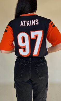 FINAL SALE Cincinnati Bengals football jersey - number 97. Black base, white breathable sides & orange sleeves. "Atkins" on the back. Never been worn. ﻿Size YOUTH large - fits similar to an adult medium. Throwback Black Jersey For Sports Season, Black College Football Season Jersey, Black Number Print Top For Game Day, Casual Black Jersey For Game Day, Black Sports Tops With Number Print For Events, Sporty College Jersey For Football Season, Sporty College Football Season Jersey, Team-colored Sporty Jersey For Football Season, Sporty Team Logo Jersey For Football Season