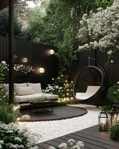 an outdoor living area with white furniture and flowers on the ground, surrounded by greenery