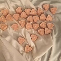 small heart shaped candles on a white cloth