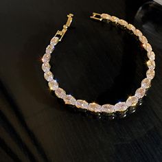 14K Gold Plated on Alloy Cubic zirconia stones Length: 167mm - 6.5" Weight: 9.5g Cubic Zirconia (Swarovski Element crystal) set in Lead-free, Eco-friend and hypoallergenic setting. This stunning bracelet is then Gold Plated to ensure a long-lasting and brilliant finish. Elegant Crystal Tennis Bracelet With Bling, Dazzling Cubic Zirconia Bracelets With Rhinestones, Elegant Bling Crystal Bracelet, Dazzling Crystal Tennis Bracelet With 17 Jewels, Diamond Crystal Bracelet With Sparkling Stones As Gift, Diamond Tennis Bracelet With Rhinestones As Gift, Diamond Tennis Bracelet With Rhinestones For Gift, Diamond Rhinestone Tennis Bracelet As A Gift, Gift Crystal Bracelet In Diamond White Cubic Zirconia