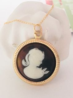 "Coffee Cameo Necklace, Gold Filled Cameo Necklace, Victorian Necklace, Cameo Pendant, Cameo jewelry, Cameo Pearl Necklace, Romantic Gift ♡ Ivory White on Coffee background Lady Cameo  ♡ Set in a Gold plated 25mm (1\") round frame ♡ Dainty 14k Gold filled chain, 18\" with spring ring clasp  ♡ Crafting materials are from the USA  ♡ Handcrafted with Love & Care in Redondo Beach, CA ♡ Your purchase will arrive in a gift bag or box. ♡ Invoices are not included in packages. ♥ Thank you! ~ Penelope's Cameo Round Pendant Necklace Gift, Cameo Round Pendant Necklace For Gift, Cameo Medallion Jewelry Gift, Cameo Medallion Jewelry For Gifts, Cameo Round Pendant Necklace For Wedding, Victorian Cameo Round Necklace, Victorian Round Cameo Necklace, Wedding Necklaces With Cameo Round Pendant, Cameo Jewelry Gift