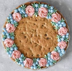 a cake decorated with pink and blue flowers