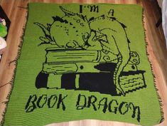 a green rug with the words i'm a book dragon on it