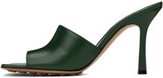 Grained lambskin slip-on heeled sandals in green. · Open square toe · Logo-embossed at padded lambskin footbed · Covered stiletto heel with rubber injection · Leather sole with rubber injections · Heel: H3.5 in Supplier color: Pine green Modern Green Mules With Sculpted Heel, Chic Green Mules For Formal Occasions, Green Open Toe Formal Mules, Luxury Green Heels With Padded Heel, Elegant Green Open Heel Mules, Green Pointed Toe Mules With Padded Heel, Green Evening Mules With Padded Heel, Green Leather Mules With Padded Heel, Elegant Green High Heel Mules