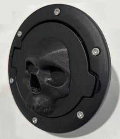 a black clock with a skull face on it