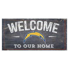 a wooden sign that says welcome to our home with the chargers logo in white on it