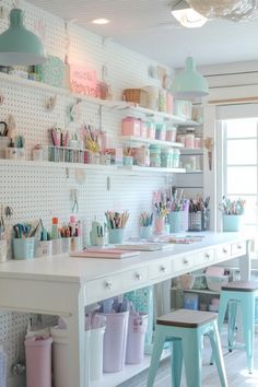 an organized craft room with lots of craft supplies on the shelves and desks in pastel colors