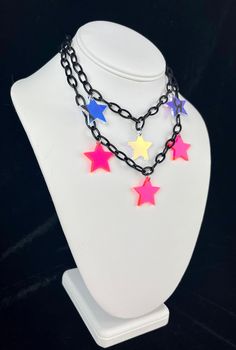 FREE Shipping on orders $35 and up! Star Girl Choker The Star Girl choker is made with high-quality lightweight material, perfect for raves and festivals! The iridescent star charms shine and reflect prisms of light under the sun. - Charms are made with lightweight iridescent acrylic- color appearance changes depending on lighting - Adjustable from 14 to 16 inches (message me for length customizations up to 20-22inches) Matching earrings here!- https://www.etsy.com/listing/1380601428/star-irides Punk Star-shaped Necklace For Parties, Rainbow Adjustable Choker For Festival, Rainbow Adjustable Choker For Festivals, Pink Rave Jewelry For Festival, Trendy Multicolor Star Necklace, Trendy Multicolor Star Shaped Necklace, Multicolor Rave Jewelry For Festival, Multicolor Rave Festival Jewelry, Handmade Rainbow Choker For Festival