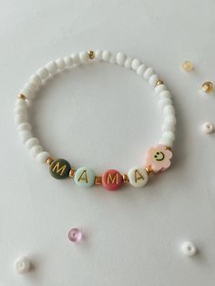 MAMA bracelet.  Perfect for stacking together with other bracelets or wearing separately.  Approximately 6.75 inches, could be made bigger or smaller, just send me a message.  Beads are 4mm, white and gold. 6mm Letter beads, colors will vary but we will try our best to have alternating colors. Mama Stack Bracelets, Mom Bead Bracelets, Mama Bracelet Beads, Beaded Bracelet Words, Mom Bracelet Ideas, Adjustable White Jewelry For Mother's Day, White Adjustable Bracelets For Mother's Day, Adjustable White Bracelets For Mother's Day, White Beaded Jewelry For Mother's Day