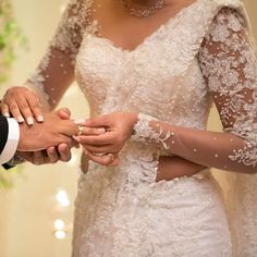 the bride and groom are exchanging their wedding rings