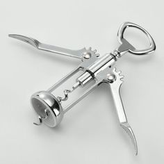 a pair of scissors that are sitting on a white surface with the handles down and one is open