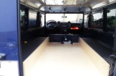 the interior of a blue bus with its door open