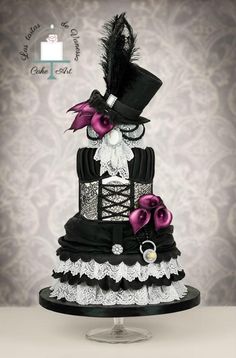 a black and white wedding cake with pink accents