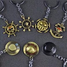 several different types of key chains with pirate symbols on them, all in gold and black