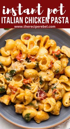 a plate full of pasta with spinach and chicken in it, on top of a white table cloth