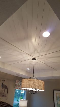 a lamp hanging from the ceiling in a living room