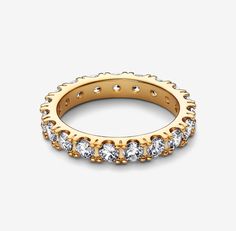 Make a classic statement with the Sparkling Row Eternity Ring. Hand-finished in 14k gold-plated sterling silver, this eternity ring features a band inlaid with sparkling clear cubic zirconia. The design looks equally beautiful worn solo or stacked with other rings. Style it with bands in similar tones to create a monochromatic look, or go for contrasting metals for a combination that pops. A classic silhouette with a modern interpretation, this ring is designed to be a wardrobe essential for yea Dazzling Gold Eternity Band Gift, Gold Round Band Jewelry With Vvs Clarity, Gold Cubic Zirconia Eternity Band With Diamond Cut, Dazzling Gold Eternity Band With Prong Setting, Gold Cubic Zirconia Round Band Jewelry, Gold Cubic Zirconia Jewelry With Channel Set, Gold Cubic Zirconia Eternity Band With Prong Setting, Luxury Gold Eternity Band With Channel Set, Luxury Gold Channel Set Eternity Band