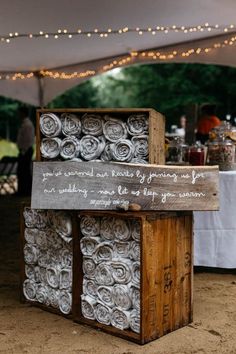 an old wooden box is sitting under a tent