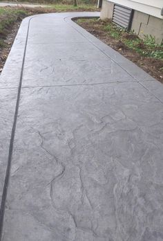 a concrete walkway in front of a house