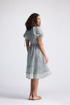 Dramatic sleeves and a fitted bodice make this midi dress one you can’t miss. This pretty dress is perfect for casual sunny days out in the park or brunching with your girls. The tiers, puff sleeves, the contemporary print, ruffled hem and bow ties come together beautifully to make it an effortless and versatile outfit that can be dressed up or down! Wash in cold water or dry clean only Do not soak bleach or wring Line dry in shade Iron inside out on low heat Modest Midi Dress With Gathered Sleeves For Daywear, Modest Knee-length Midi Dress With Gathered Sleeves, Flowy Puff Sleeve Dress For Garden Party, Modest Fitted Puff Sleeve Summer Dress, Summer Feminine Midi Dress, Casual Midi Dress With Gathered Sleeves And Square Neck, Spring Prairie Dress With Puff Sleeves For Brunch, Summer Puff Sleeve Maxi Dress For Garden Party, Summer Maxi Dress With Puff Sleeves For Garden Party