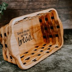 a wooden bread basket with the words give us this key to our daily bread