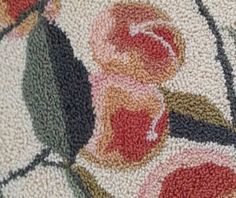 a close up view of a rug with flowers on it