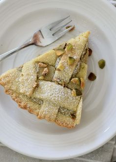 a piece of pie sitting on top of a white plate with a fork next to it