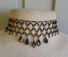 To bead this choker, I did netted weave using: black bugle beads, brass and bronze, size 9 and 10, seed beads; and faceted, Czech glass, bronzedrop beads.   The length is adjustable; starting at 31.5 cm. (12 3/8"), up to 48.5 cm. (19 1/8").  It closes with a black, lobster claw clasp. If you would prefer the tail looped up rather than dangle,  just let me know at time of purchase;  and I can easily add a hook at the end.  The last photo shows more of my work.   If you don't see the listing in my shop, contact me and, chances are, if I don't have it in stock I can probably make a custom necklace for you. This is a simple version of the amazing collars made by Native-Americans, for centuries, up to the present.  To see some examples, go to the National Museum of the American Indian (NMAI), a Elegant Evening Wear, Craft Sewing, Bugle Beads, Beaded Choker Necklace, Drop Beads, Beaded Choker, Custom Necklace, Lobster Claw, Czech Glass